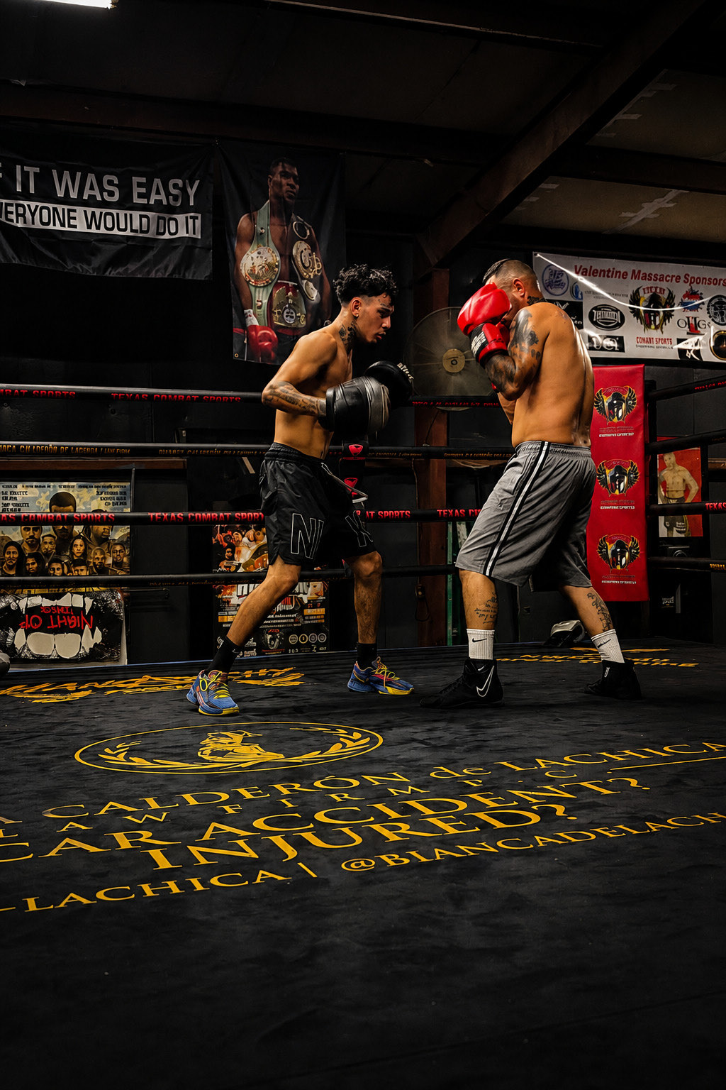 Andrew sparring in the ring, gloves up and moving in on his training partner
