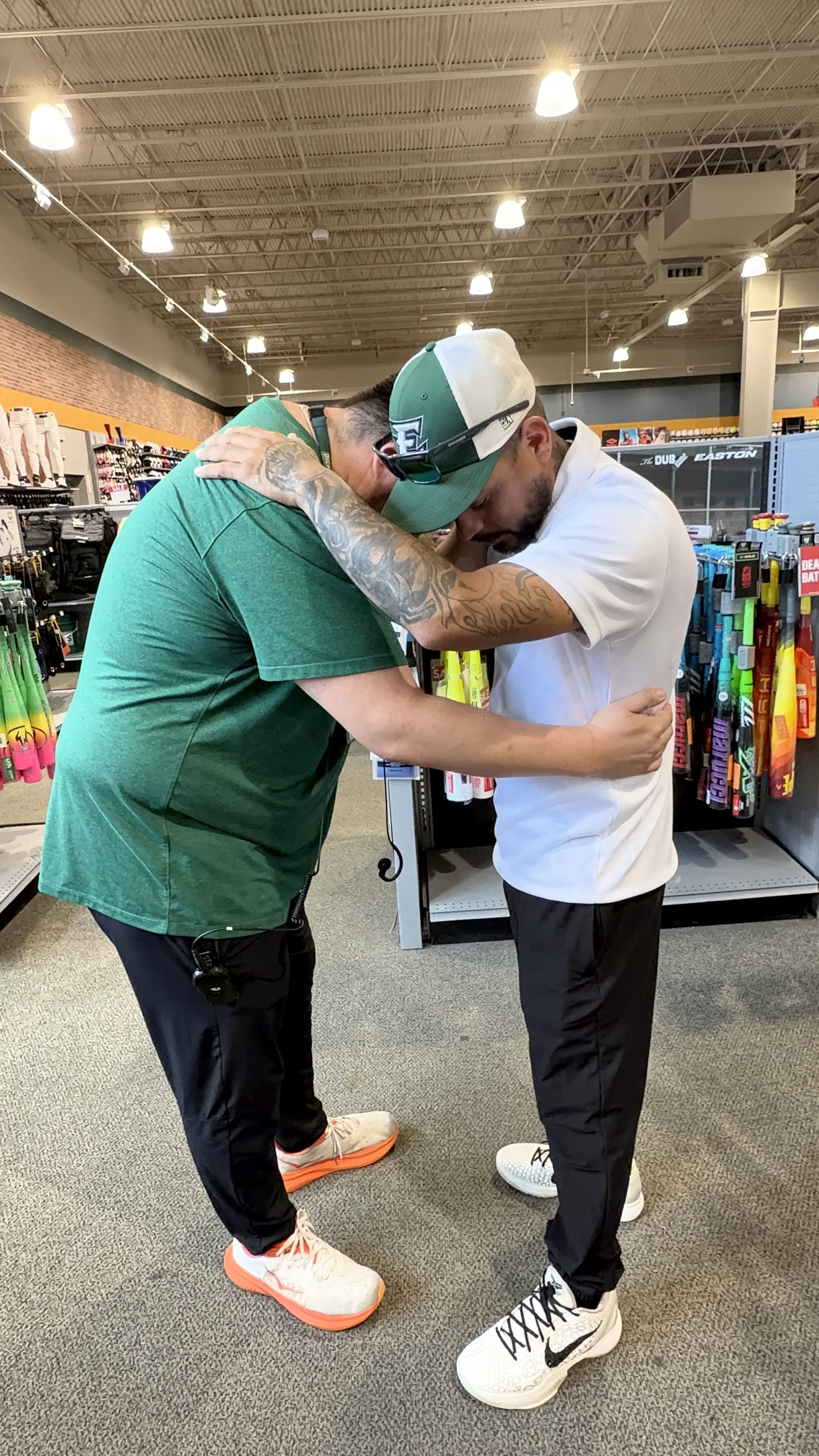 Coach Andrew embracing a supporter at a community event