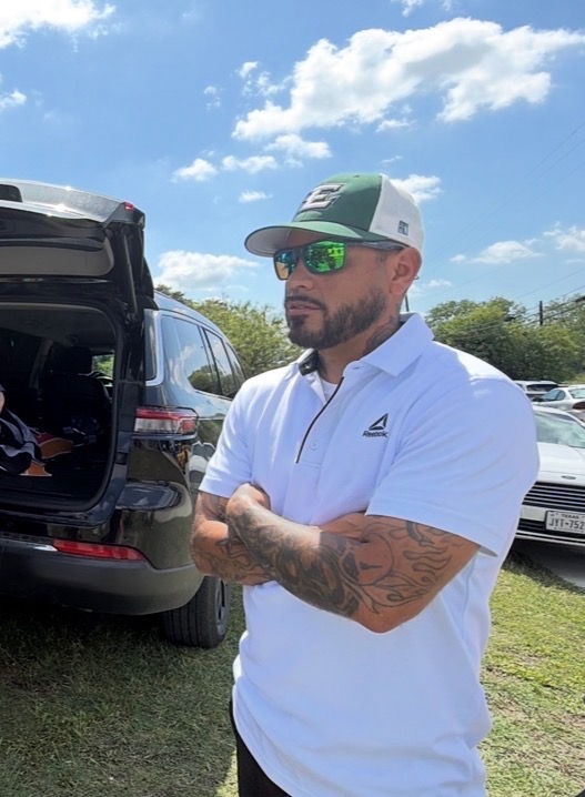 Coach Andrew at a youth football field