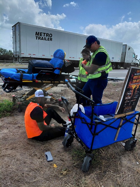 Andrew being treated by paramedics on the roadside on day three of the Houston to San Antonio walk