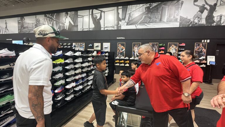 Kids being fitted for new cleats at a sporting goods store